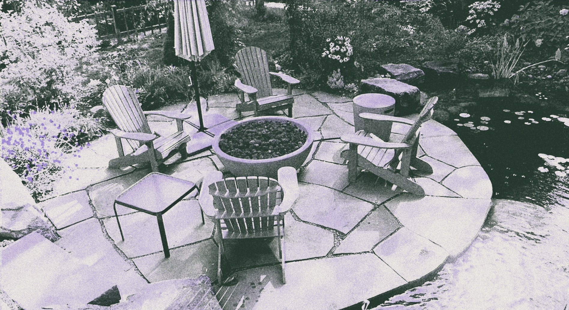Wooden chairs on a flagstone patio beside a garden pond with lily pads, printed in green and lavender